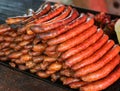 piles of many cooked frankfurters in the street food stall Royalty Free Stock Photo