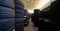 Piles of new tires in tyre warehouse in car garage