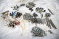 Piles of nuts bolts srews and different hardware on a drop sheet Royalty Free Stock Photo