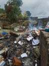 Piles of paper archives and documents burn outdoors in a controlled fire, destroying old files for security or disposal. Royalty Free Stock Photo