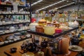 Piles of plates, crockery and ceramics on shelves in charity shop interior view, charity chic for up cycle, recycle, reuse and re