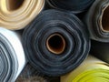 Piles of rolls of textile fabrics of various colors Royalty Free Stock Photo