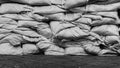 Piles of sandbags to prevent flooding on the cement floor.