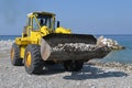 Piles of shingle dumped on the beach shore replenish and widen.