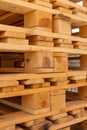 Piles of stacked natural wooden shipping pallets