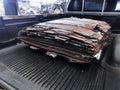 Piles of steel plates placed at the back of the truck to prepare for use in industrial products with selective focus on
