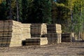 Piles of swamp mats used to build roads in muskeg