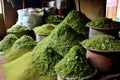 piles of tea leaves in different stages of processing