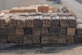 Piles of wooden planks at the seaport berth. Warehouse for sawing in stacks for loading in the open air. Material wooden wooden b