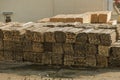 Piles of wooden planks at the seaport berth. Warehouse for sawing in stacks for loading in the open air. Material wooden wooden b