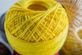 Piles of yellow colored balls yarn background.