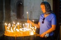 Pilgrim lighting a candle, Orthodox Good Friday, Holy Sepulchre church