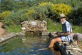 Pilgrim takes footbath in water basin