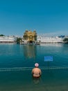 Pilgrim taking holy bath in holy water of The Golden Temple in Amritsar, Punjab, India. Royalty Free Stock Photo