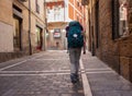 Pilgrim walking in Pamplona's street along the Way to Santiago de Compostela