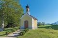 pilgrimage chapel and bench in the bavarian alps, summer landscape