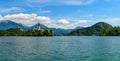 The Pilgrimage Church of the Assumption of Mary on the island of Lake Bled is a symbol of Slovenia on a background of alpine