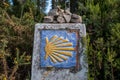 Old milestone with shell symbol on a old tile - Way of St. James