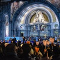 Pilgrims attend the Marian Torchlight Procession service at the Rosary Basilica in Lourdes Royalty Free Stock Photo