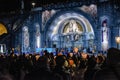 Pilgrims attend the Marian Torchlight Procession service at the Rosary Basilica in Lourdes Royalty Free Stock Photo