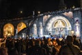 Pilgrims attend the Marian Torchlight Procession service at the Rosary Basilica in Lourdes Royalty Free Stock Photo