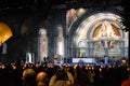 Pilgrims attend the Marian Torchlight Procession service at the Rosary Basilica in Lourdes Royalty Free Stock Photo