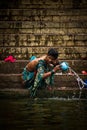 Pilgrims bathe and wash in the holy waters of the Ganges, Varanasi, India