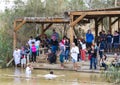 Pilgrims from different countries accept the rite of baptism in the Jordan River in Israel