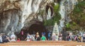 Pilgrims enter the cave of Lourdes, France Royalty Free Stock Photo