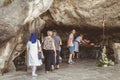 Pilgrims enter the cave of Lourdes, France Royalty Free Stock Photo
