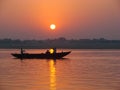 Pilgrims floating by boat of the sacred Ganges river. Sunrise in Varanasi, Uttar Pradesh, India. Royalty Free Stock Photo