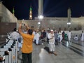 Pilgrims gather at night in the outer courtyard of Masjid Al Nabawi, Madinah.