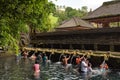 Pilgrims in the holy water pool in Pura Tirta Empul, a Hindu Balinese water temple in Bali