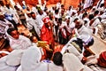 Lalibela, Wollo, Ethiopia, circa november 2008: Pilgrims kissing cross after atending the service outside of rock hewn church Royalty Free Stock Photo