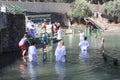 Pilgrims take baptism in the waters of the Jordan