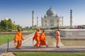 Pilgrims in traditional orange clothes at the Taj Mahal, Agra, Uttar Pradesh state, India