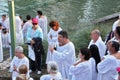 Pilgrims waiting his turn in white christening shirt. Royalty Free Stock Photo