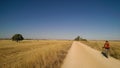 Pilgrims walking on a dirt road on the way of Saint James, camino de santiago, Spain.