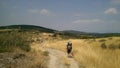 Pilgrims walking on a dirt road on the way of Saint James, camino de santiago, Spain.