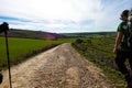 Pilgrims with walking sticks - The holy french Way of `Camino de Santiago` in Winter. Pilgrimages on their journey through Spain