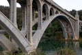 Pilings and arches of the Rogue River bridge in Gold Beach, Oregon at sunset reflected in water Royalty Free Stock Photo