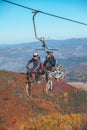 Pilipets, Ukraine - October 10, 2021: bicyclers with mountain bikes on chairlift Royalty Free Stock Photo