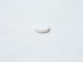 Pill of aspirin on white background.