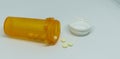 Pill bottle with pills spilling out Royalty Free Stock Photo