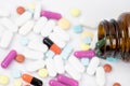 Pill bottle spilling out. colorful pills on to surface tablets background. Royalty Free Stock Photo