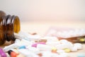 Pill bottle spilling out. colorful pills on to surface tablets on a table wooden background. top view. drug medical Royalty Free Stock Photo