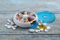 Pill box with medicaments on wooden table