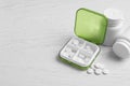 Pill box with medicaments on white wooden table. Space for text Royalty Free Stock Photo