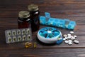 Pill boxes with medicaments on wooden table