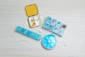 Pill boxes with medicaments on white wooden table, flat lay